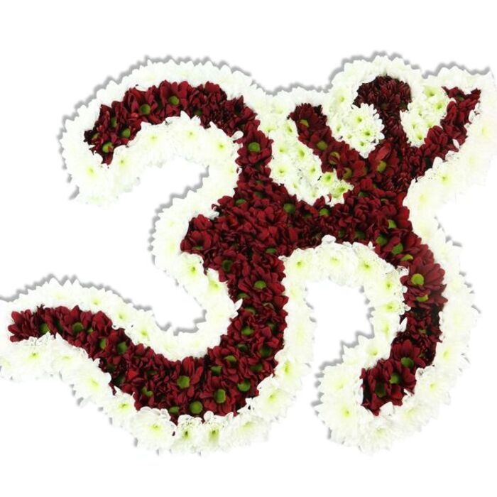 Rendered with patient, exacting care by a local florist in Chessington, this floral Om emblem is a study in contrast and texture. The symbol's main body is densely built from dark red to maroon chrysanthemum-type blooms, each small flower showing a bright lime-green disk at its heart that breaks the dark surface with natural luminosity. A thick, scalloped border of pure white spray chrysanthemums frames the entire form, tracing every curve and lifting the symbol from the white background with a crisp, devotional outline. Under soft, even lighting the tiny petals form a tapestry of shadow and highlight; the drop shadow below suggests a modest elevation, giving the arrangement a sculptural presence that reads as both tactile and refined. The overall effect is solemn yet hopeful: the deep reds convey gravity and depth, while the white edge and green centers introduce purity and life. The composition is suited to spiritual gatherings, cultural festivals, yoga and meditation spaces, or remembrance ceremonies held locally-from a community hall near Leatherhead Road to a quiet corner near Horton Country Park-where its visual language of reverence will resonate. Crafted with botanical knowledge and a florist's steady hand, this piece demonstrates how simple materials-chrysanthemum heads and thoughtful placement-can create a powerful, serene emblem that comforts the eye and honours tradition. Chessington Florist prepares such tributes with sensitivity and care for community rituals and private commemoration.